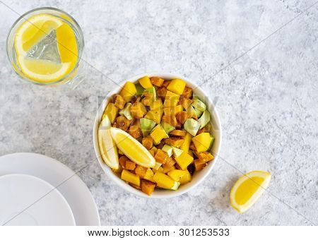 Pegan Salad With Mango, Avocado And Sweet Potatoes, Served With Lemon Water. Paleo Diet. Pegan Diet.