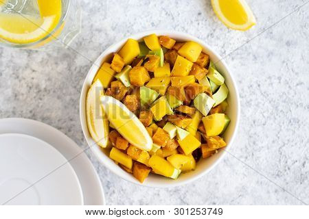 Pegan Salad With Mango, Avocado And Sweet Potatoes, Served With Lemon Water. Paleo Diet. Pegan Diet.