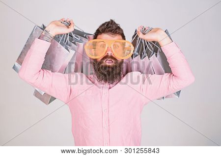 How To Get Ready For Your Next Vacation. Man Bearded Hipster Wear Sunglasses While Carry Lot Shoppin