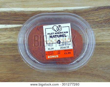 Amsterdam, The Netherlands - May 15, 2019: Package Of Filet Americain Naturel Against A Wooden Backg