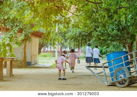 Back View Of Kindergarten Students Run Back To The Classroom After Having Lunch.