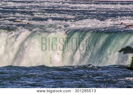 Gorgeous View Of Niagara Falls Landscape.waves Rumbling Against The Rocky Shore. Beautiful Nature Ba