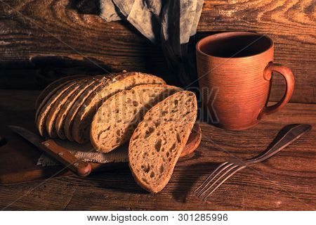 Rural Still Life With Homemade Bread On Rustic Background In The Morning Light