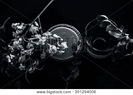 Bunch Of Flowers Of Drumstick On Wooden Surface Along With Its Extracted Water Or Tincture In A Glas