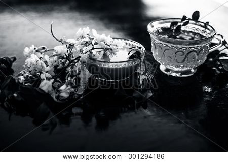Bunch Of Flowers Of Drumstick On Wooden Surface Along With Its Extracted Tea And Paste Of Flowers In