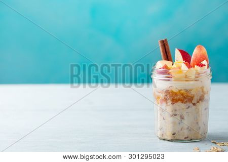 Overnight Oats, Bircher Muesli With Apple, Cinnamon And Honey. Blue Background. Copy Space