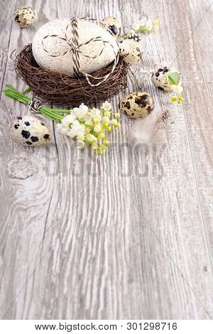Easter Background With Natural Eggs And Lily Of The Valley Flowers On Wooden Table, Space For Your T