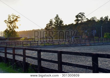 Sunset Rays Of The Sun Beautiful Against The Cloudy Sky Near The Place For Walking Horses