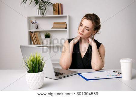Woman In Office Massaing Her Neck. Sick Female Worker.