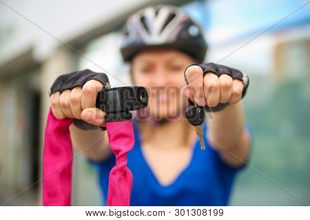 Girl with bicycle  lock. Bicycle lock. Bike protection