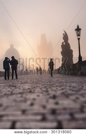 Prague, Czech Republic - March 27 2016: Spectators Watch The Dense Fog On Charles Bridge On The Brig