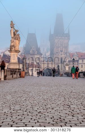 Prague, Czech Republic - March 27 2016: Spectators Watch The Dense Fog On Charles Bridge On The Brig