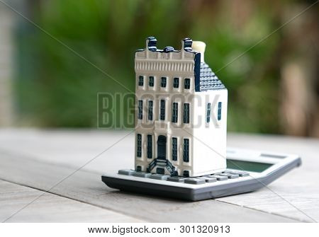 Property House With Calculator, Concept For Real Estate Or Mortgage And House Finance Or Loan