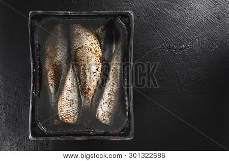 Marinated Mackerel Or Herring Fish With Spices Packed In Box On Slate Stone Background. Mediterranea