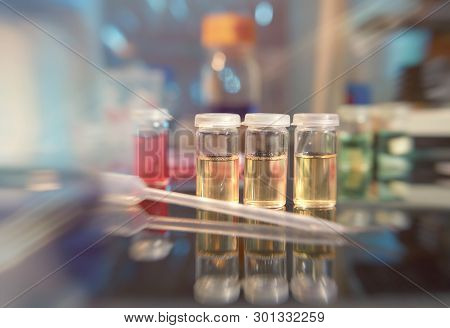 Microbiology Background. Liquid Bacterial Cultures On The Bench, Shallow Dof, Focus On The Three Yel