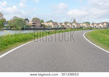 Empty Curved Road On A Dam In The Dutch Countryside, Capelle Aan Den Ijssel, Netherlands