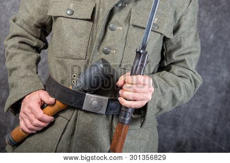 A Ww Ii German Soldier With Rifle And Grenade