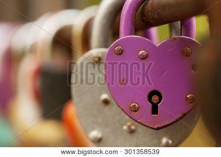 Padlocks Hang On The Fence Of The Bridge As A Symbol Of Love, Loyalty And Joint Happiness