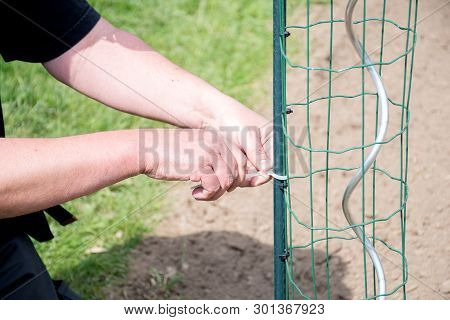 Gardening Handman Working In Garden To Preparing Garden With Cutting,and Tight Plastic With Grill To