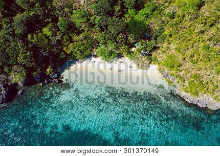 Top Down View Of Tropical Beach With Turquoise Water And White Sand
