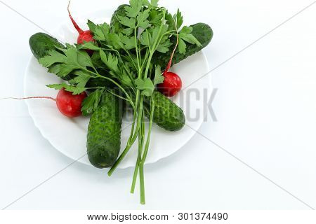 Red Radishes, Cucumber, Small Prickly Green And A Bunch Of Parsley. Light Background