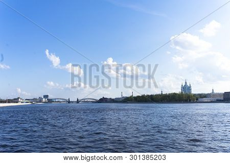 View From The Sverdlovsk Embankment, St. Petersburg. River Neva On The Spring. Smolny Cathedral In T
