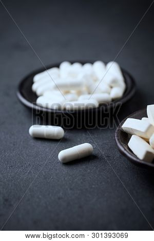 Glutamine And Bcaa Amino Acids. Nutrition For Bodybuilding. Fitness Supplements On Black Stone Backg