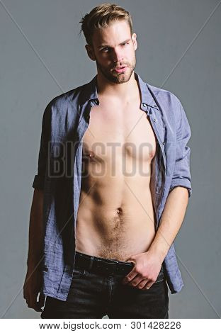 Feeling Flirty. Guy Sexy Muscular Body Take Off Clothes Grey Background. Full Desire. Seductive Mach