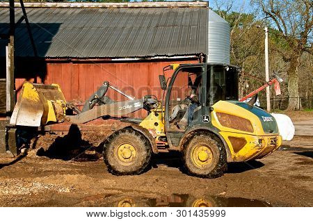Rowley, Massachusetts, April 28, 2019: The 204k John Deere Front End Loader Hauling Silage Is A Prod