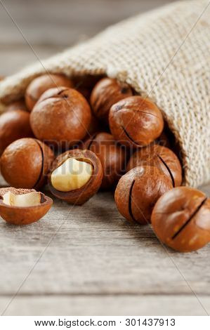 Macadamia Nut On A Wooden Table In A Bag, Closeup, Top View