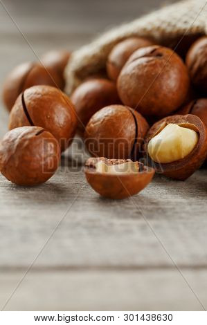 Macadamia Nut On A Wooden Table In A Bag, Closeup, Top View
