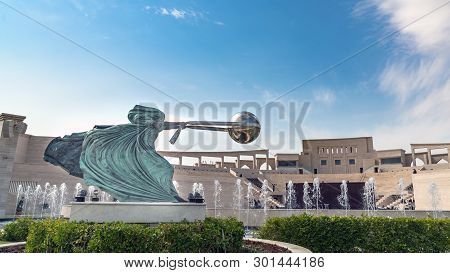 Doha, Qatar- January 2019: Katara Cultural Village With Statue In Foreground And The Amphitheater In