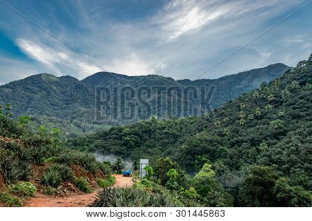 In This Image Solo Traveller Camping Experience Is Expressed With His Bike And Tent. In The Backgrou