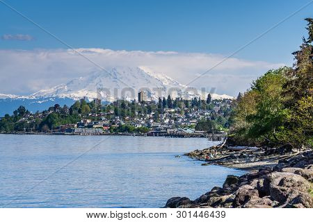 Majestic Mount Rainier Towers Over The Ruston Shoreline Near Tacoma, Washington.