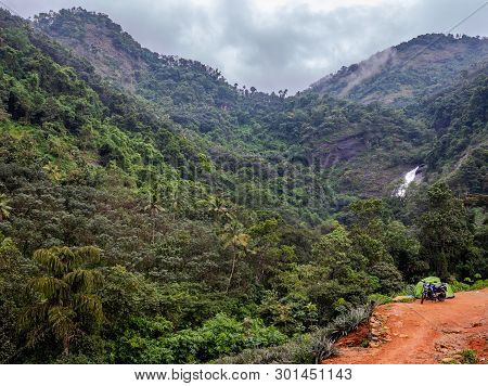 In This Image Solo Traveller Camping Experience Is Expressed With Hills, Waterfall And Green Forests