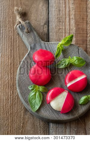 Small Snack Cheeses On The Wooden Board