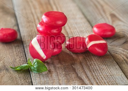 Small Snack Cheeses On The Wooden Board