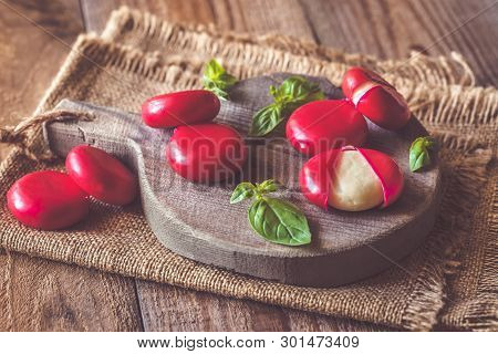 Small Snack Cheeses On The Wooden Board