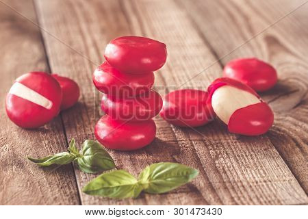 Small Snack Cheeses On The Wooden Board