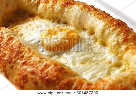 Adjar Khachapuri In A White Rectangular Plate On An Isolated White Background Closeup