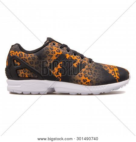 Vienna, Austria - August 10, 2017: Adidas Zx Flux Black And Orange Sneaker On White Background.