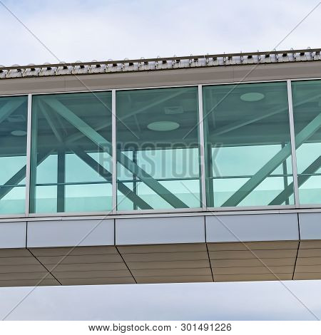 Clear Square Looking Up At An Empty Skybridge With A Cloudy Blue Sky In The Background