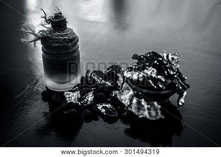 Raw Organic Amli Or Tamarind Or Imli In A Clay Bowl On Wooden Surface With Its Extracted Herbal Esse