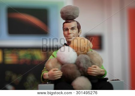 MAY 15 2019: Recreation of a scene from Star Trek Original Series episode The Trouble with Tribbles. Captain Kirk covered by a pile of Tribbles. Mego action figure used.