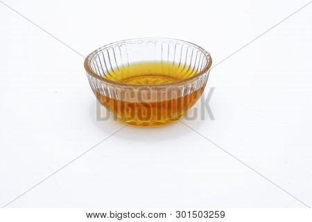 Raw Organic Honey Or Nectar In A Transparent Glass Bowl Isolated On White.