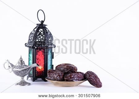 Ramadan Food And Drinks Concept. Ramadan Lantern With Arabian Lamp, Wood Rosary, Dates Fruit And Lig