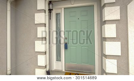 Clear Panorama Green Front Door With Sidelight On The Facade Of Home Viewed Against Cloudy Sky