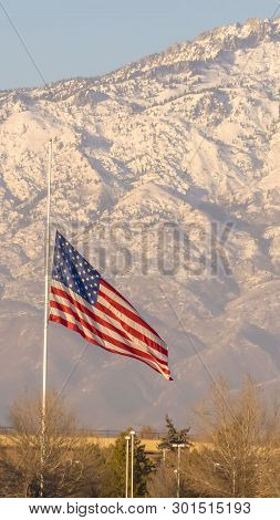 Vertical American Flag And Building With Mount Timpanogos And Sky In The Background