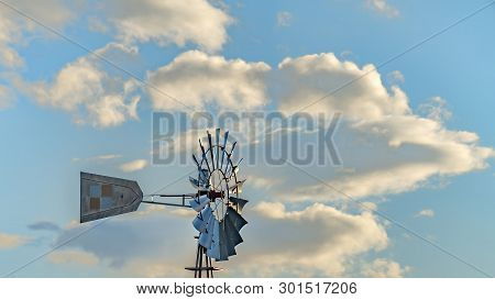 Panorama Windpump With A Snow Covered Mountain And Cloudy Blue Sky In The Background