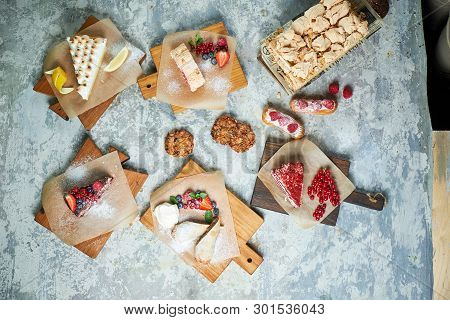 Assorted Sweet Desserts. Top View. Gray Textured Background. Beautiful Serving Dishes. Dessert. Food